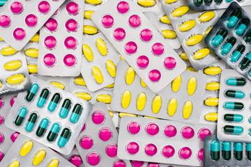 Top view of colorful pile of pills in blister packs. Drug use with reasonable concept. Global healthcare wallpaper.