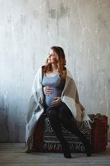 Happy pregnant woman in studio.