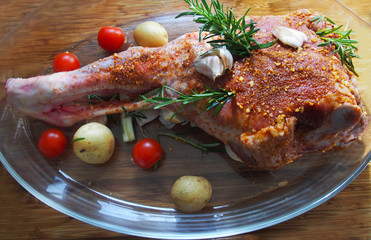 Fresh and raw meat. Leg of lamb on wood background