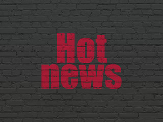 News concept: Painted red text Hot News on Black Brick wall background