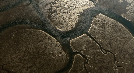 aerial image taken on a cold winter day of the Bay Bassin d'Arcachon at low tide, revealing a...