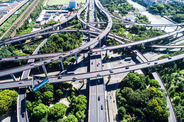 Aerial view massive highway intersection, stack interchange with elevated road junction overpass at...