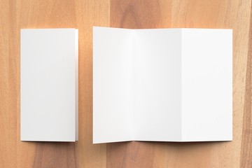 Thrifold - Three fold brochure mock up on wooden background. 3d illustrating.