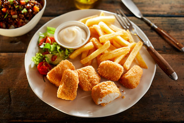 Plate of crispy golden kibbeling with French Fries