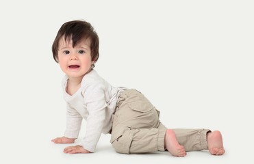 Portrait of a cute sweet baby crawling in the studio