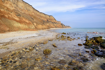 Lonely sea shore with sand cliffs.