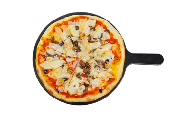 Pizza whole round on a black tray, blackboard, cut into pieces, on a white isolated background. Fast food in a pizzeria, a floury cheese product. View from above