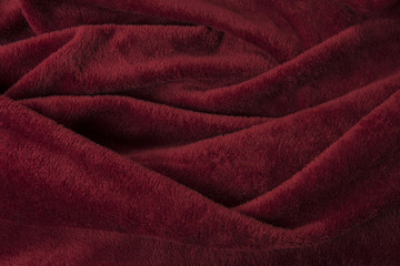 Full-frame burgundy red velvet cloth with curves