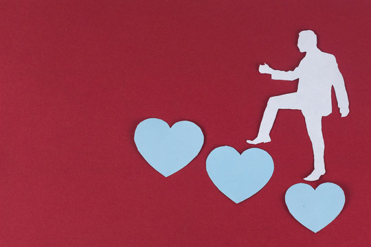 Cheating, jealous, obsession, possession, Unfaithful concept. paper man is climbing treading on hearts
