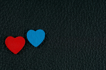 valentine's day card, red and blue hearts on black leather