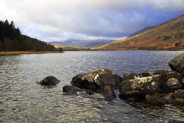 Storm clouds over moody Snowdon mountains across Lake Llyn Mymbyr