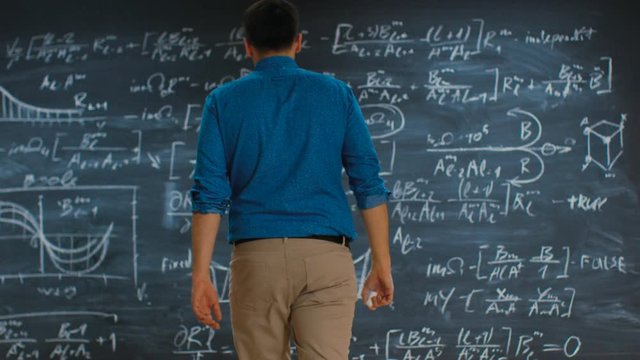 Brilliant Young Mathematician Approaches Blackboard and Finishes Solving Long and Complex Equation.