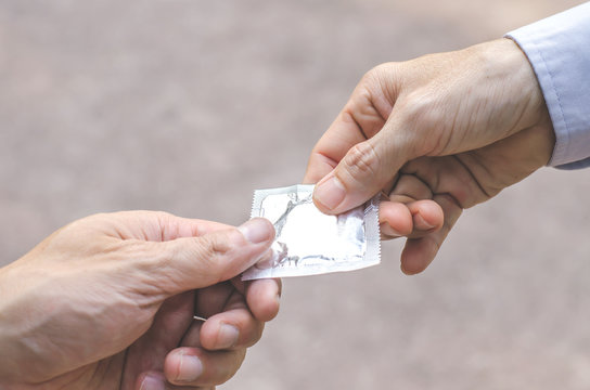 man giving condoms, promote healthy lifestyle concept