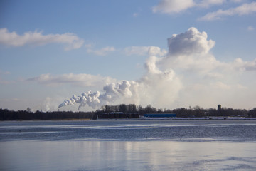 Naklejka na ściany i meble white chimney smoke in oil terminal Latvia sunny day winter river daugava in Latvia