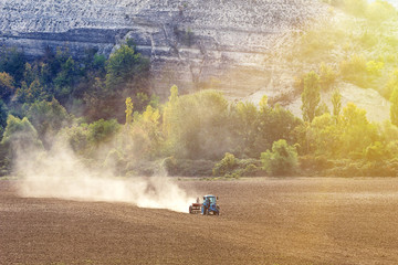 Tractor cultivating field, aerial view  of rural scene in Crimea, Ukraine.