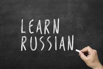 Obraz premium Human hand writing text on blackboard: Learn english