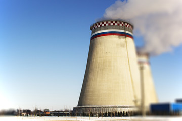 Obraz premium Thermoelectric power station with smoke pipe on the background of blue sky.