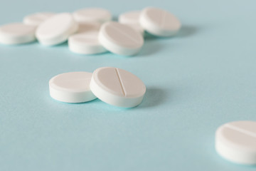 White pills on the bright blue background.