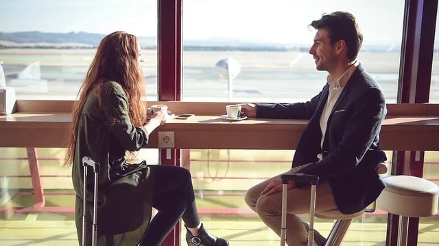 Content couple having coffee at airport