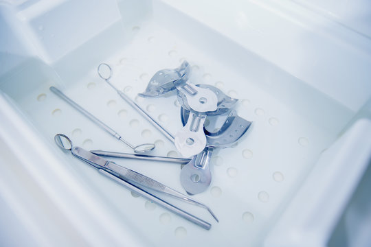 Medical instruments of the dentist in the tray for disinfection, cleaning.
