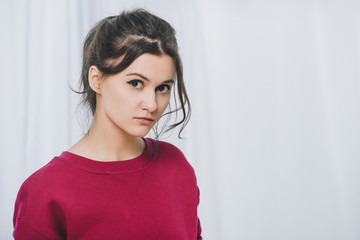 Pretty lady in red sweater on white background