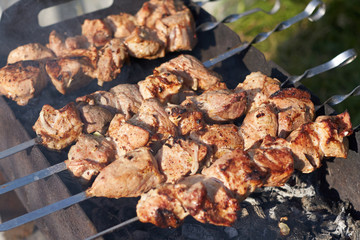 Appetizing meat grilled on skewers. Cooking shashlik.
