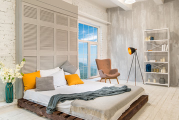 Cozy light bedroom with scenic view from the window