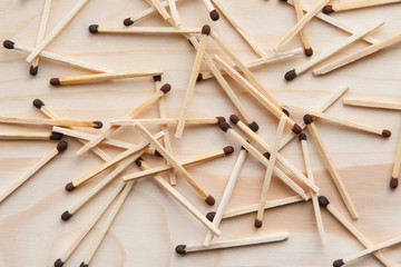 The wooden unburned matches are thrown out by a slide against the background of a light brown tree