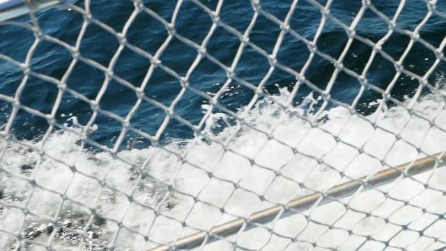 Slow motion of boat with bouy cruising through ocean water