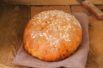 Homemade onion bread on a napkin. Wooden background. Rustic style.