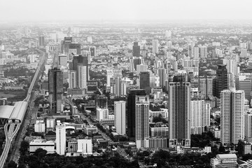 black and white photo. view of the bangkok from above. large road interchange. skyscrapers downstairs