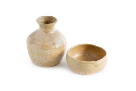 Japanese Sake drinking in ceramic jars and ceramic glass isolated on a white background