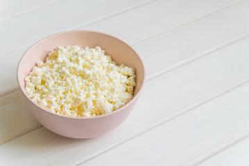 Cottage cheese with apples for breakfast in a bowl close up. Top view image. Cottage cheese with apples for breakfast in a bowl close up. Blue polka dot napkin. Top view image. Copyspace for your text