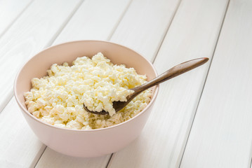 Cottage cheese with apples for breakfast in a bowl close up. Top view image. Cottage cheese with apples for breakfast in a bowl close up. Blue polka dot napkin. Top view image. Copyspace for your text