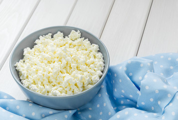 Cottage cheese with apples for breakfast in a bowl close up. Top view image. Cottage cheese with apples for breakfast in a bowl close up. Blue polka dot napkin. Top view image. Copyspace for your text