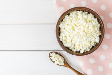 Cottage cheese with apples for breakfast in a bowl close up. pink polka dot napkin. Top view image. Copyspace for your text