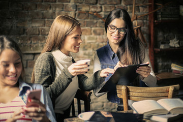 Three students girls in cafe.