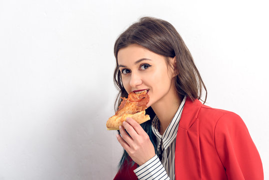 Young Woman Eating Pizza On White Background