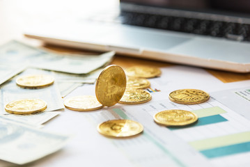 golden bitcoin coin on us dollars close up.