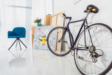 Bicycle and blue chair in stylish light room