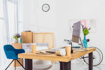 Paper cups on work space table with computer