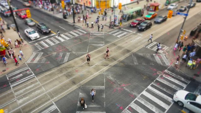 Toronto, Ontario, Canada, time lapse view of people and traffic crossing busy intersection at Yonge-Dundas Square.