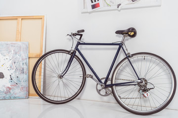 Fototapeta na wymiar Bicycle by the wall in stylish light room