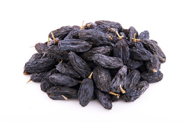 Dark raisins on a white background.