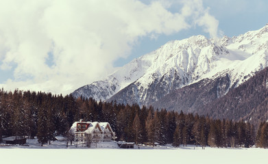 mountain landscape with house hotel covered with snow