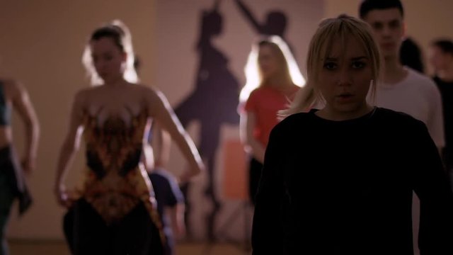 Young caucasian people are dancing in studio