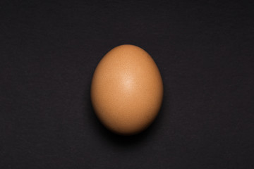 Egg close-up on a black background. View from above