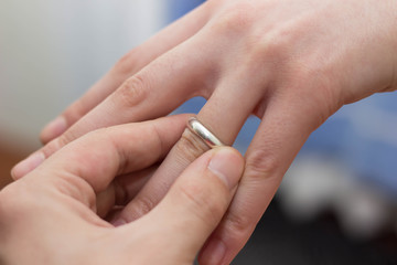 guy puts a ring on a girl finger