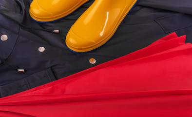 Raincoat and umbrella and rubber boots.