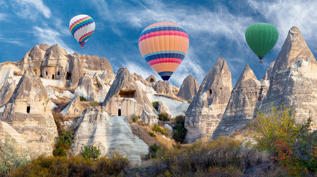 Colorful hot air balloons flying over valley in Cappadocia, Anatolia, Turkey